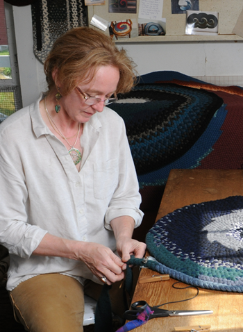 Delsie Hoyt braiding a rug